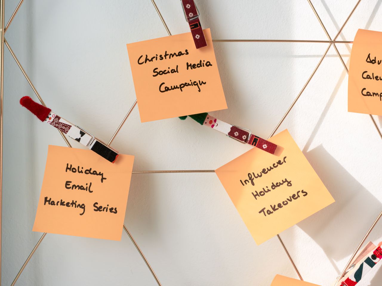 Sticky notes showing holiday marketing concepts for Christmas social media and email campaigns.